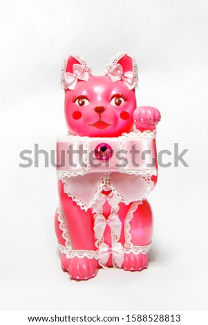 Pink and cute ribbon beckoning cat