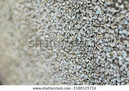 Fine gravel. Closeup of a layer of stones of various shapes. Focus on the right third of the frame. The far-off perspective of the picture. Abstract background for many tasks. Selective focus.