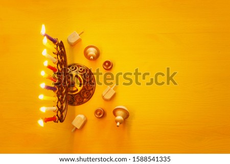 religion image of jewish holiday Hanukkah background with menorah (traditional candelabra), candles and spinning top
