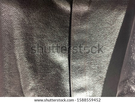 Silver shiny heat protective thermal clothing texture background macro closeup detail shot. Protection against fire and heat, safety work wear, security and fireproof material pattern abstract concept Royalty-Free Stock Photo #1588559452