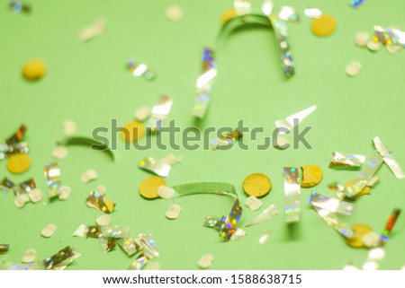 Confetti on colorful mint background. Celebrating concept. Copy space 