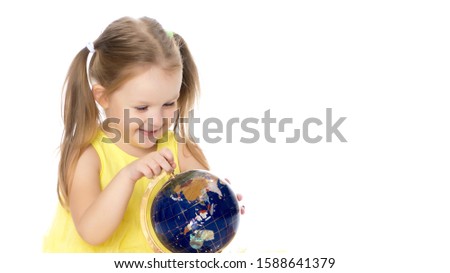 A little girl looks at the Globe.