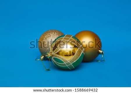 Gold toys with blue background ornaments. Christmas atmosphere.