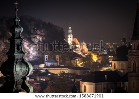 Illuminated Stadtpfarrkirche Mülln in historic city center of Salzburg in Austria at night