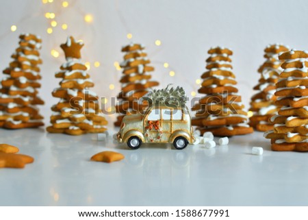Christmas card with toy retro car ,with bokeh New Year's lights. . Cozy christmas with gingerbread cookies, cinnamon, cardamom