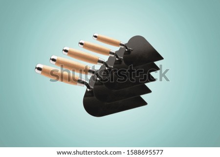 collection of construction spatulas over light blue  background, tools for repair