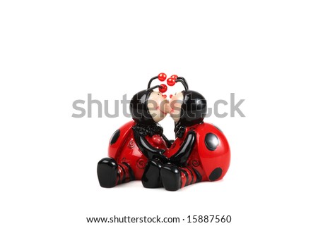 souvenir of two kissing ladybirds isolated on white; concept of love