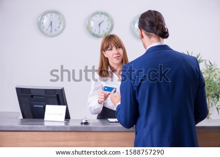 Young businessman at hotel reception