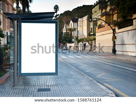 Blank electronic advertising poster with blank space screen for your text message or promotional content, clear banner in urban setting, empty poster at a bus stop, public information billboard