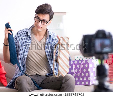 The male fashion blogger recording video for vlog