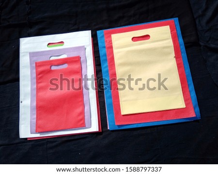 beautiful eco handbags non woven fabric bags on Black background, friendly shopping bags