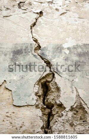 Vertical big crack on an old brick wall. Several of deep cracked line. Close up. Copy space. Royalty-Free Stock Photo #1588811605