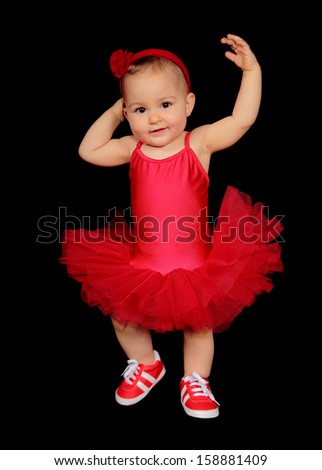 picture of a pretty baby with a dancer dress on a black background