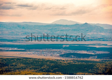 Endless autumn taiga from the height of the ridge of the crater of the Ural Mountains.