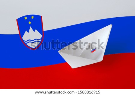 Slovenia flag depicted on paper origami ship closeup. Handmade arts concept
