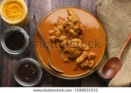 Flat lay of chicken curry and the food ingredient Delicious Asian food cuisine.  Asian food concepts picture. Turmeric, spices and black pepper.
