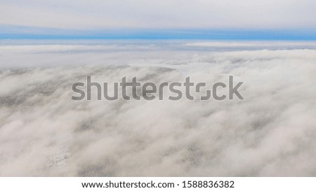 Aerial view White clouds in blue sky. Top. View from drone. Aerial bird's eye view. Aerial top cloudscape. Texture of clouds. View from above. Sunrise or sunset over clouds