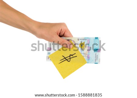 Thousand hryvnias and sticker with different financial signs and symbols in the hand, isolated