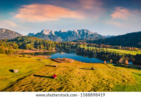 View from flying drone. Astonishing evening view of Wagenbruchsee (Geroldsee) lake with Westliche Karwendelspitze mountain range on background, Bavarian Alps, Germany, Europe. 