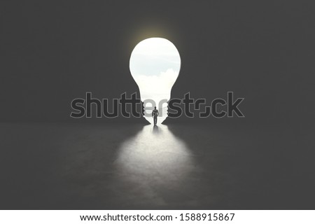 smart man walking through bulb shape door, creative concept