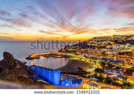 Landscape with Puerto Rico village at twilight time, Gran Canaria island, Spain Royalty-Free Stock Photo #1588922101
