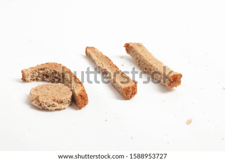 homemade letters from black bread on a white background