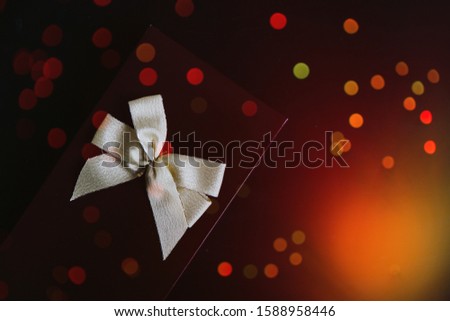 Giftbox with ribbon. Christmas present with bokeh. 