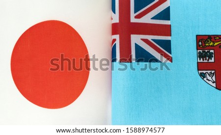 fragments of national flags of Japan and the Republic of Fiji closeup
