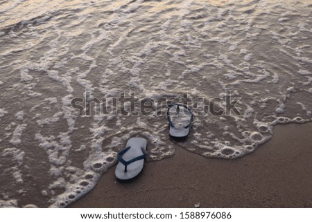 Empty shoes on the beach.