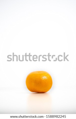 A single orange mandarin against a white background