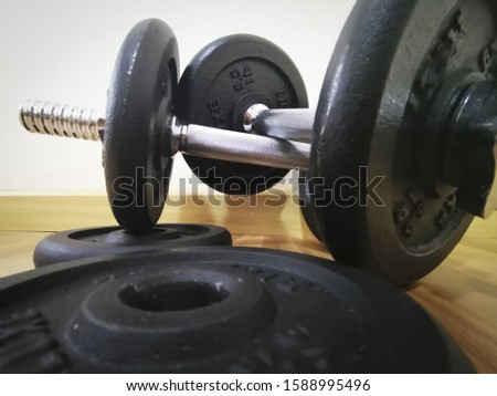 Gym and dumbbell weight training equipment on sport ,Healthy life and gym exercise equipments and sports concept ,copy space