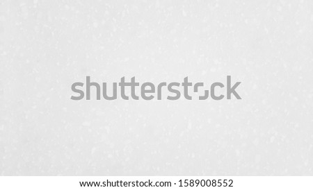 White background of blurred tile texture with white dot.
