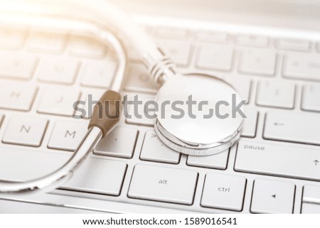 Stethoscope on a silver computer keyboard - health care concept picture