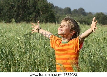 happy christian child arms raised in happiness and faith