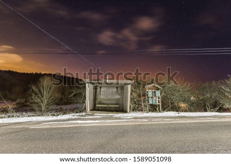 Bus stop and post boxes at night