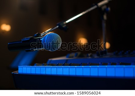 close - up piano and microphone musical instrument melody Microphone with place your text, microphone in concert hall or conference room.