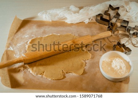 Cookie Set. A rolling pin for cookies, shapes and flour in a bowl.