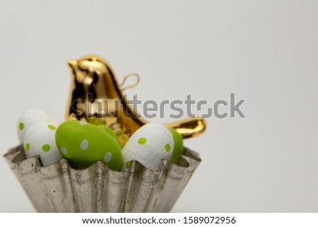 basket with Easter eggs and a bird