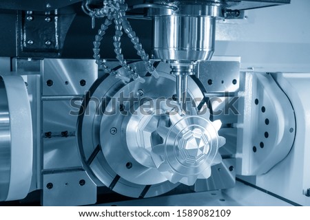 The 5-axis CNC milling machine  cutting the sample of aluminium  parts by solid ball endmill tools. The automotive parts manufacturing process by 5-axis machining center. Royalty-Free Stock Photo #1589082109