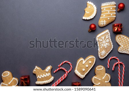 Gingerbread man. Xmas homemade Ginger, Honey cookies on dark background. Merry Christmas greeting card, banner. Winter holiday xmas theme. Happy New Year. Space for text