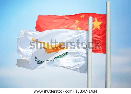 Cypriot and Chinese flags amid blue skies