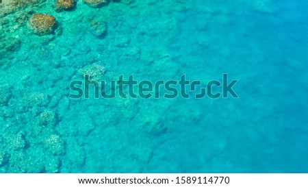 Sea surface with small waves, aerial view in blue and turquoise color tones. Seascape of coral reef and turquoise sea water, top view. Ecology concept, sea nature.