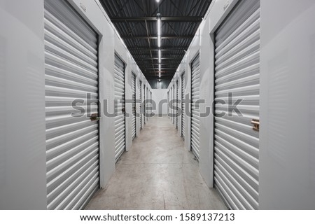 Self storage facility, metal doors with locks. Moving, storage concept.  Royalty-Free Stock Photo #1589137213