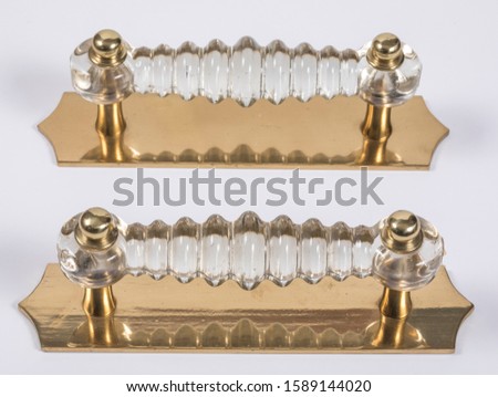 Buy made of brass door handles composition on luxury old authentic white and black backdrop.