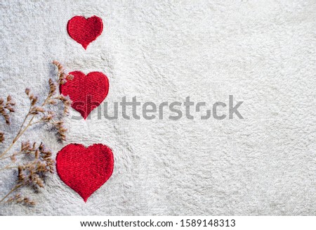 Three embroidered hearts on a white towel. Flowers Place for text. Copy space. Valentine's Day