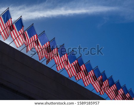 Close up of flags waving in the City Hall, blue sky with clouds. California. United States