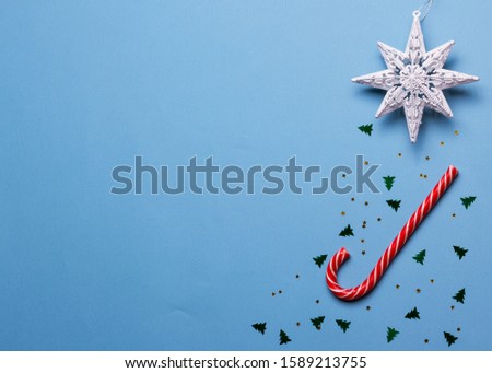 Christmas composition with stars, Christmas tree on a blue background, top view, copy space