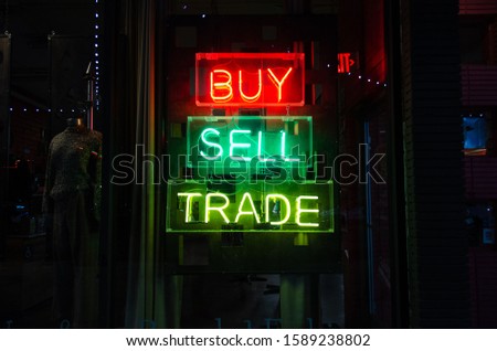 Buy Sell Trade Neon Sign at Night