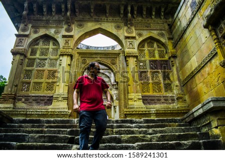 Man at Heritage Jami Masjid also known as Jama mosque in Champaner, Gujarat state, western India, is part of the Champaner-Pavagadh Archaeological Park. Jami Mosque is UNESCO World Heritage Site.