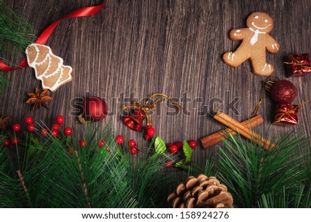 Christmas decoration with Gingerbread cookies and Christmas ornaments on rustic wood.